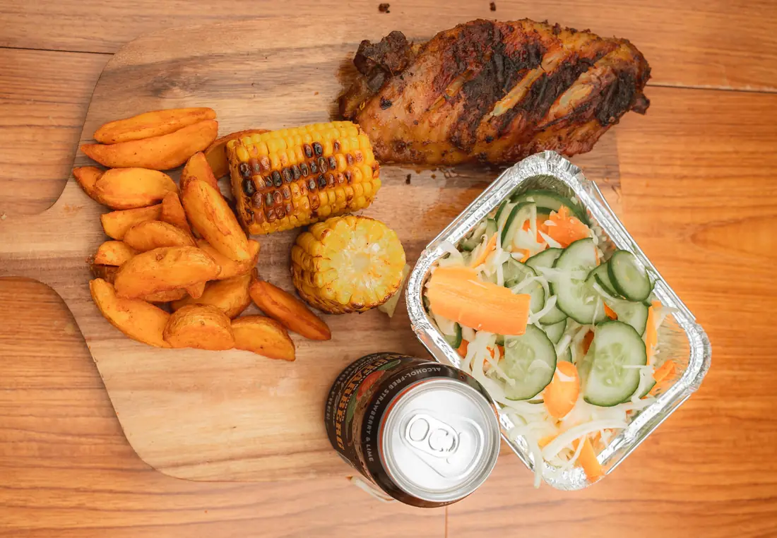 Turkey meal with potato wedges, salad, roasted corn, and Kopparberg