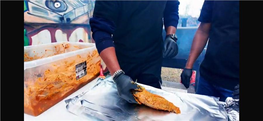 Seasoned fish being prepared for the grill
