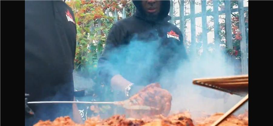 Grillpeckers flame-grilling chicken over charcoal